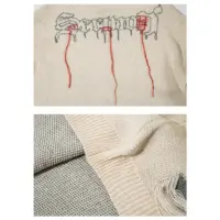 Светр «Phantom Stitch» з зображенням скелета та декоративними потертостями в чорному і кремовому кольорах.